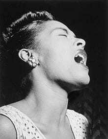Photograph of Billie Holiday singing.