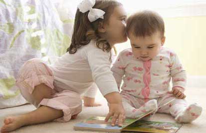 Young girl with baby reading a book