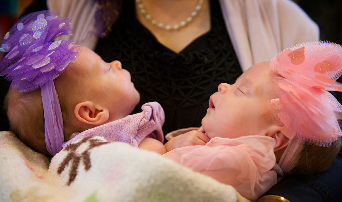 Twin Girls Arms Holding Twin Newborn Girls