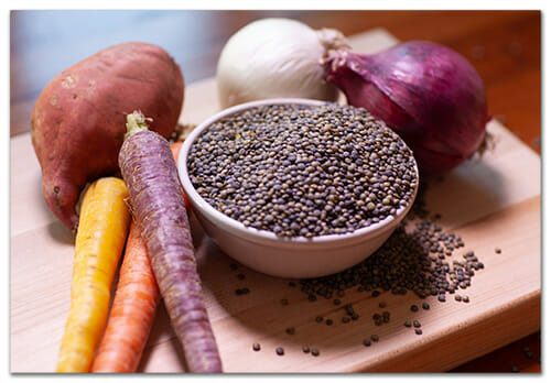 Lentils, Onions, Carrots, Sweet Potatoes on cutting board for Fertile Heart Lentil Soup