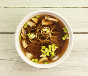 Miso Soup in White Bowl with Noodles and Scallions